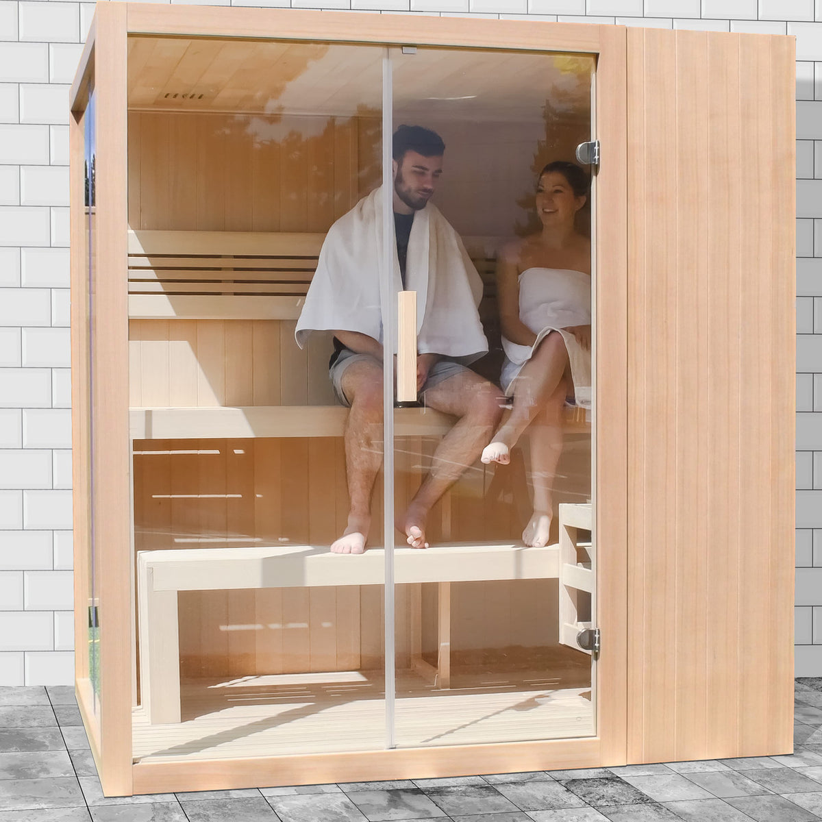 A couple using an Aleko Canadian Hemlock Indoor Wet/Dry Sauna with LED Lights 4/6 Person with 4.5 kW UL Certified Heater.