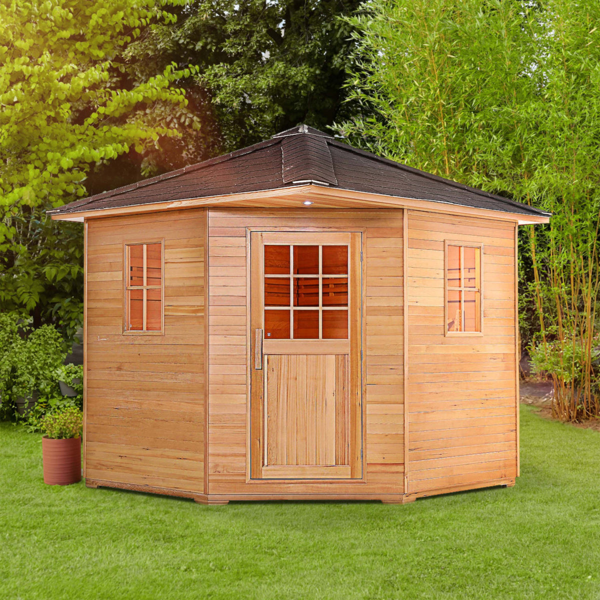 Aleko Canadian Hemlock Wet/Dry Outdoor Sauna Asphalt Roof 8 Person with 8 kW Electric Sauna Heater in a garden.