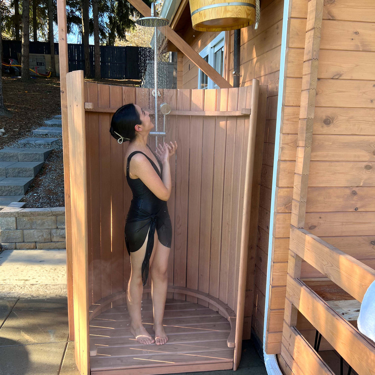 Person using Aleko Ellipse Curved Rinse Outdoor Shower.