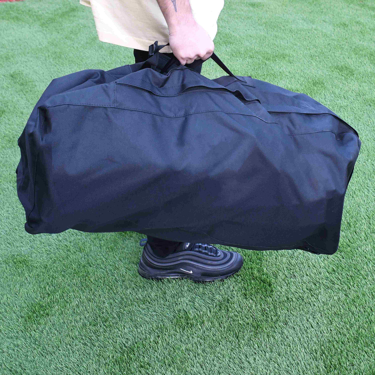 An Aleko Inflatable Cold Plunge with Locking Lid and Carry Bag being carried in its carry bag.