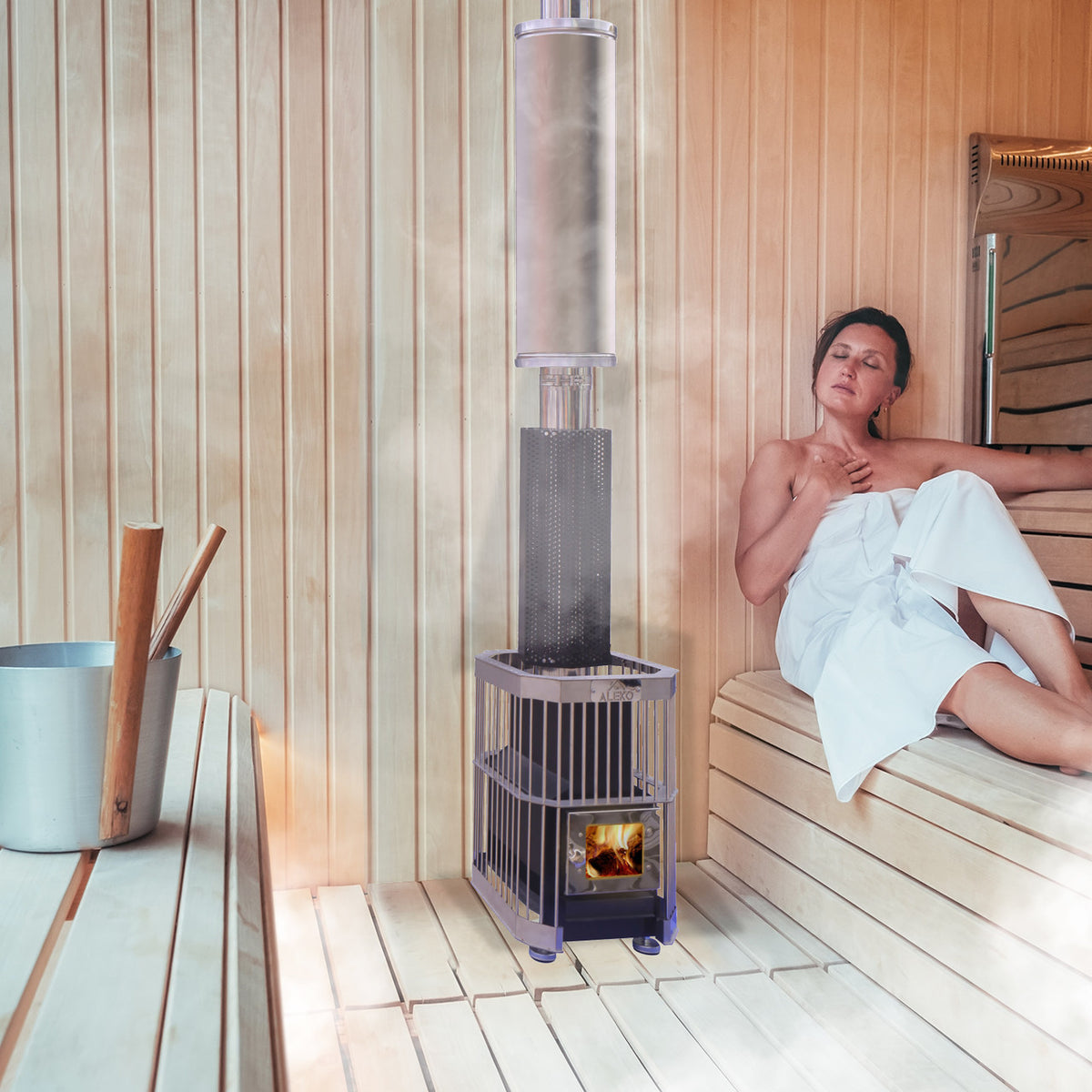 A woman using an Aleko Wood Burning Large Stone Capacity Sauna Heater and Chimney Kit 9-15 kW Equivalent in a sauna.