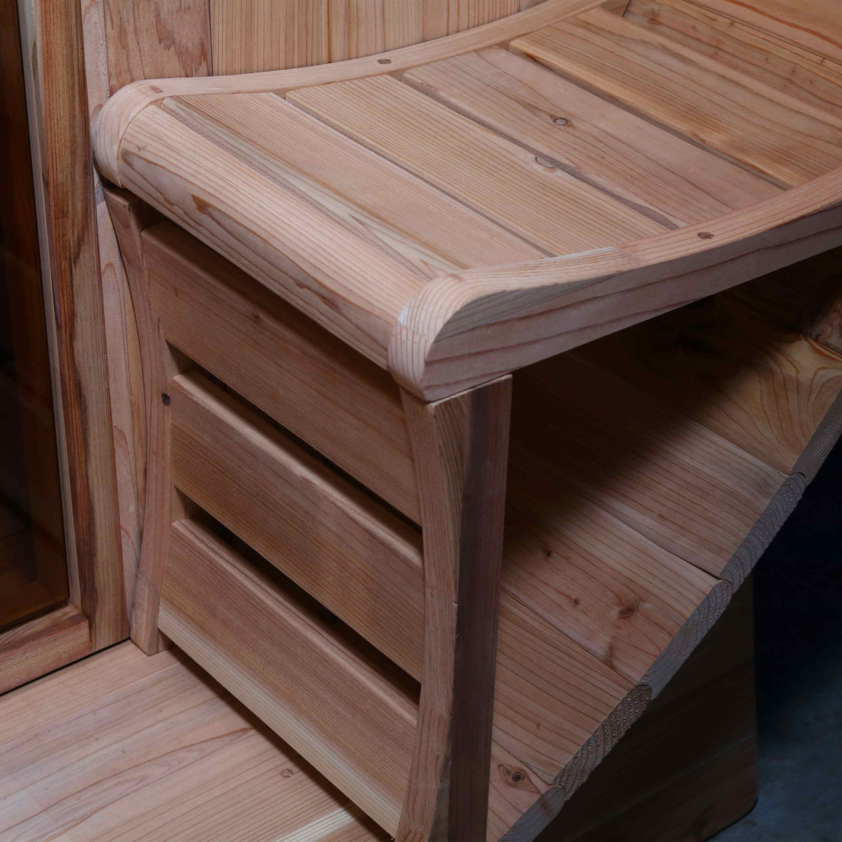 Close-up view of the Porch Canopy Seat of Aleko Red Cedar Wet/Dry 5/6 Person Outdoor Barrel Sauna with Front Porch Canopy and 6 kW KIP Harvia Electric Sauna Heater.