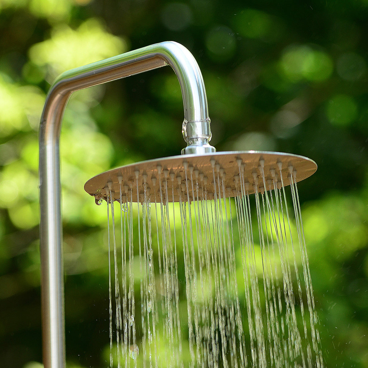 Close-up of running water from Aleko Tower Rinse Outdoor Shower&#39;s round shower head.