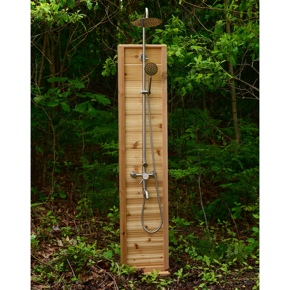 Aleko Tower Rinse Outdoor Shower set up in a natural forest setting, blending with environment.