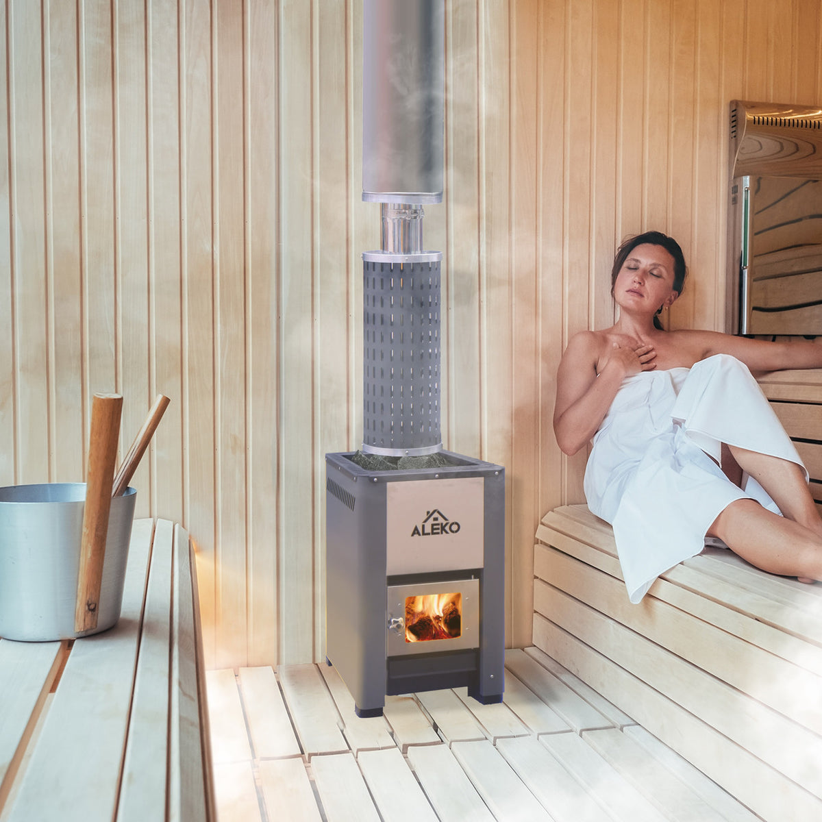 A woman using an Aleko Wood Burning Sauna Heater and Chimney Kit 9-15 kW Equivalent in a sauna.