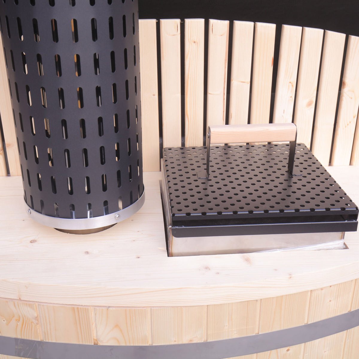 Close-up view of the heater of an Aleko Wood-Fired Pine Hot Tub with Internal Stove.