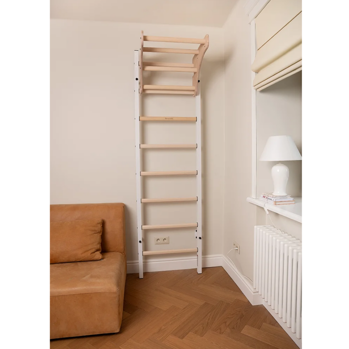 Front view of BenchK 211 Wall Bars and Gymnastic Ladders white version installed in a living room.