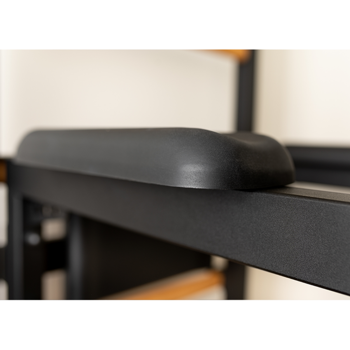 Close-up view of armrest of BenchK 222 Wall Bars and Gymnastic Ladders black version.