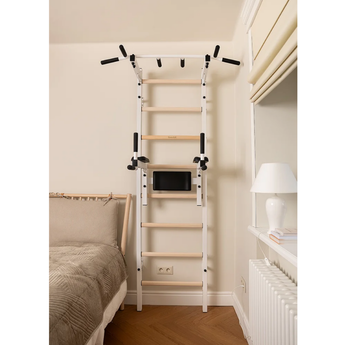 Front view of BenchK 222 Wall Bars and Gymnastic Ladders white version installed in a bedroom.