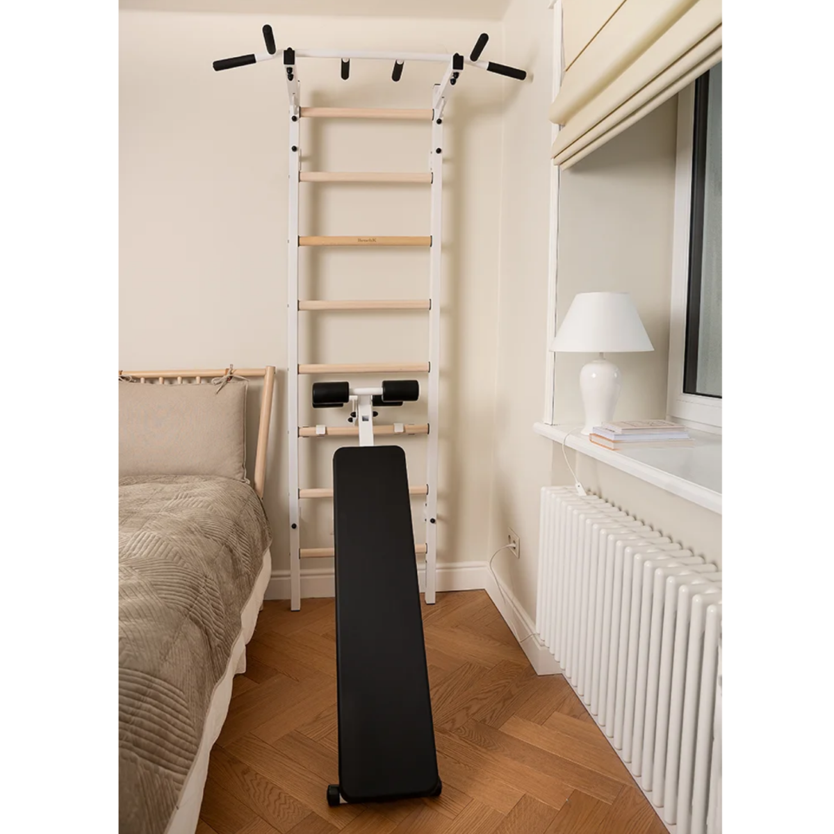 Front view of BenchK 223 Wall Bars &amp; Gymnastic Ladders white version in a bedroom.