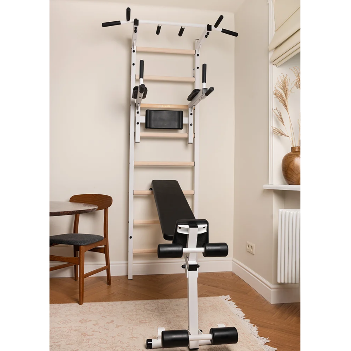 BenchK 223 Wall Bars &amp; Gymnastic Ladders white version with workout bench extended in a living room.