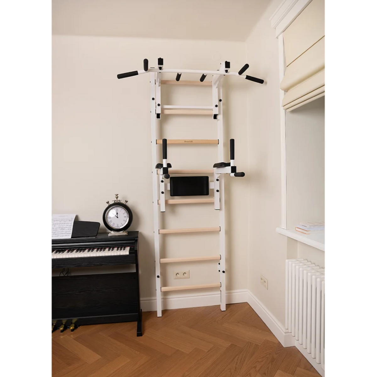 Front view of BenchK 232 Wall Bars &amp; Gymnastic Ladders white version in a living room.