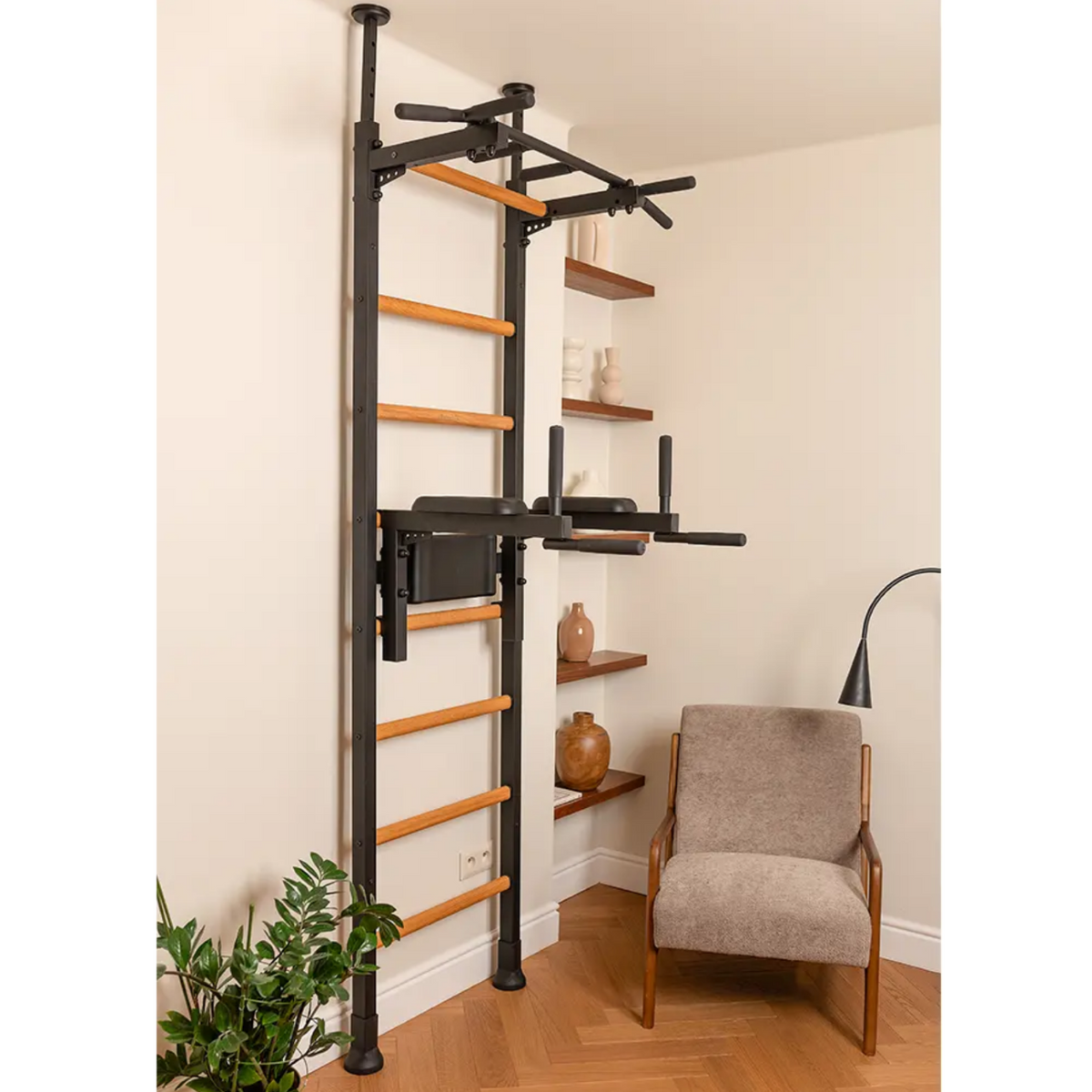 Side view of BenchK 522 Wall Bars and Gymnastic Ladders black version with pull-up bar and dip bar with back support and backrest installed in a living room.