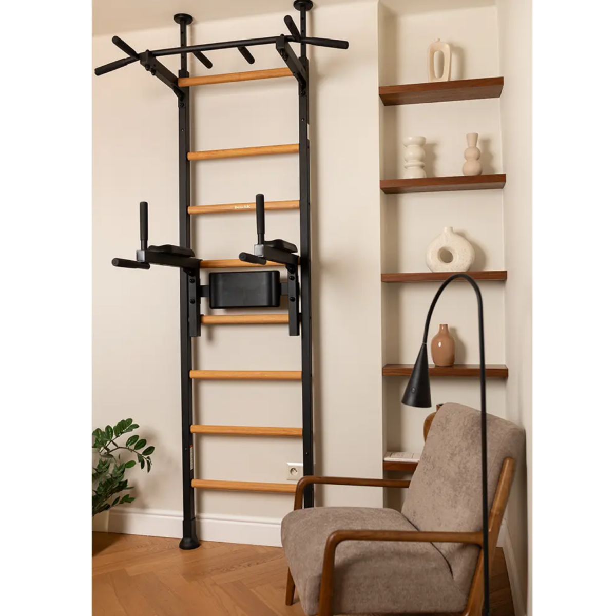 BenchK 522 Wall Bars and Gymnastic Ladders black version with pull-up bar and dip bar with back support installed in a living room.