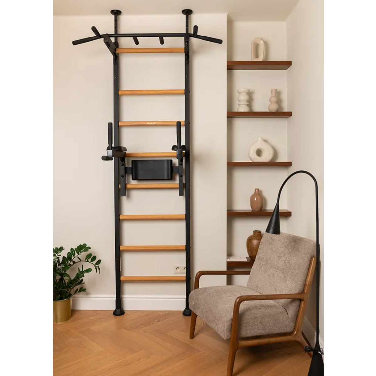 Front view of BenchK 522 Wall Bars and Gymnastic Ladders black version with pull-up bar and dip bar with back support and armrest installed in a living room.