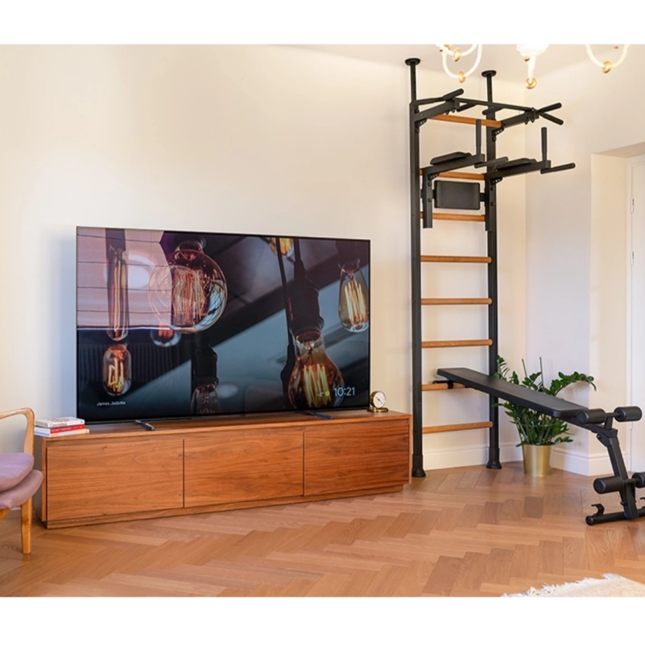 BenchK 523 Wall Bars and Gymnastic Ladders black version installed in a living room. 