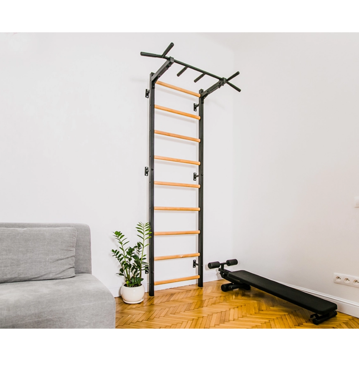 BenchK 721 Wall Bars and Gymnastic Ladders black version with pull-up bar installed in a living room.