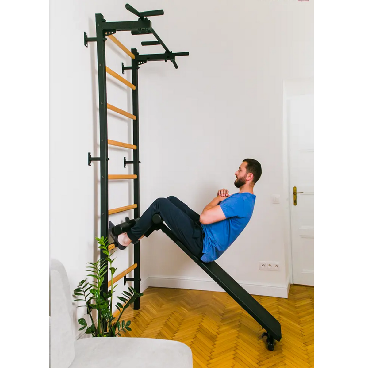 A man exercising with BenchK 723 Wall Bars and Gymnastic Ladders black version installed in a living room.