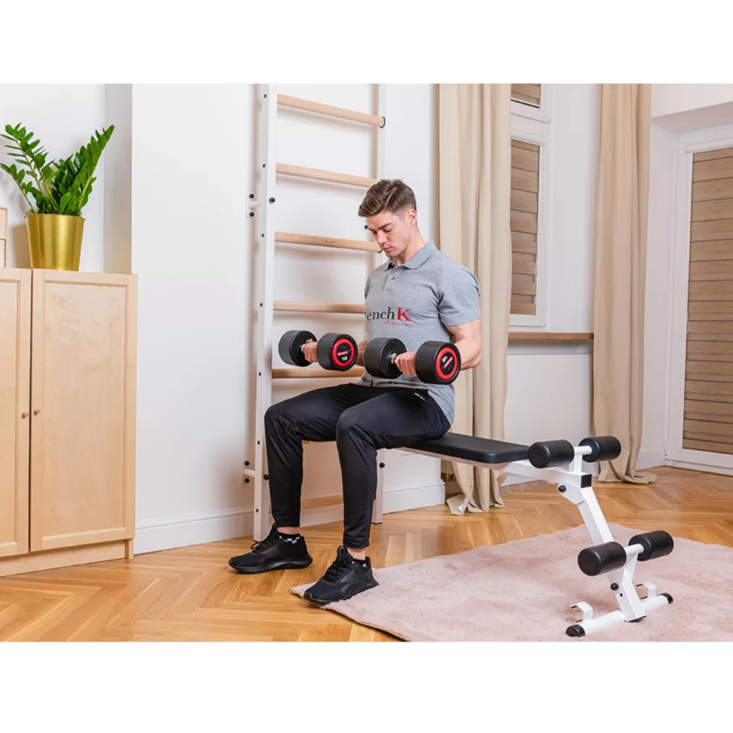 A man exercising with BenchK 723 Wall Bars and Gymnastic Ladders white version.