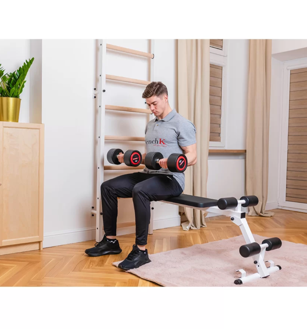 A man exercising with a BenchK 733 Wall Bars and Gymnastic Ladders white version.