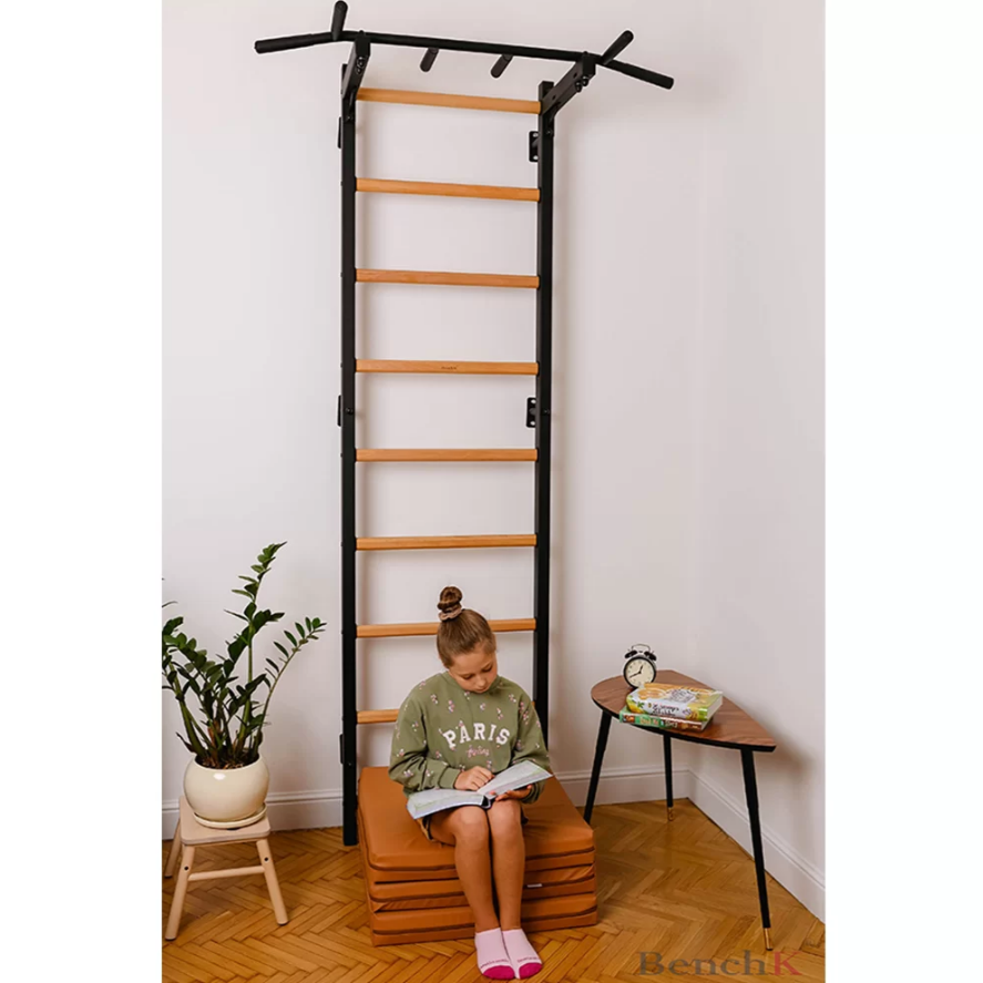 A child playing with a BenchK Foldable Gymnastic Mattress brown version.