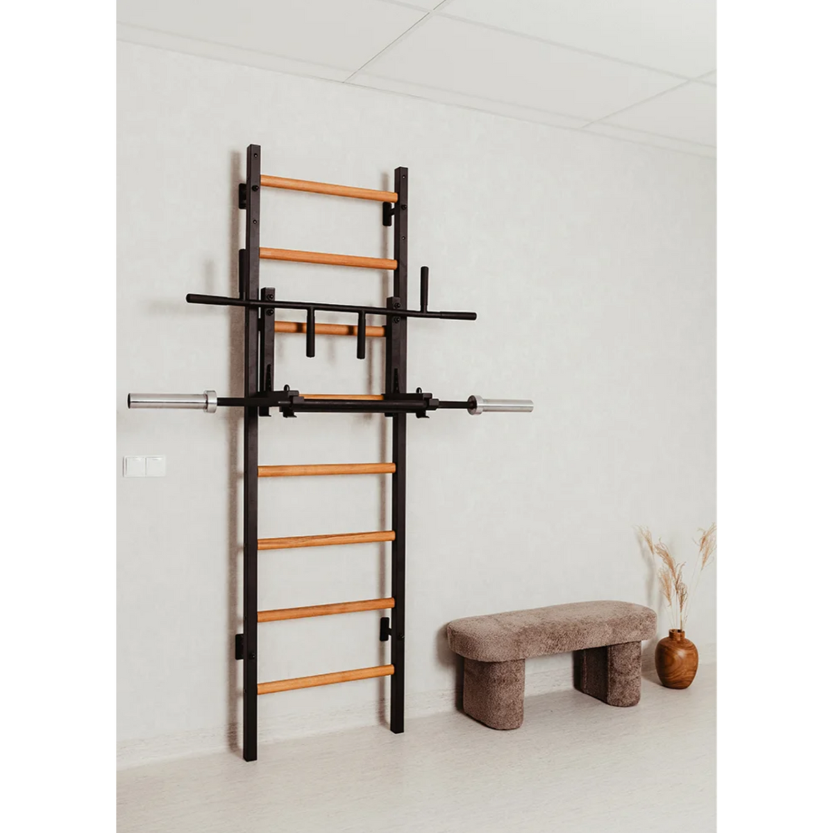 BenchK PB3 Steel Pull-Up Bar with barbell holder black version installed in a home gym.