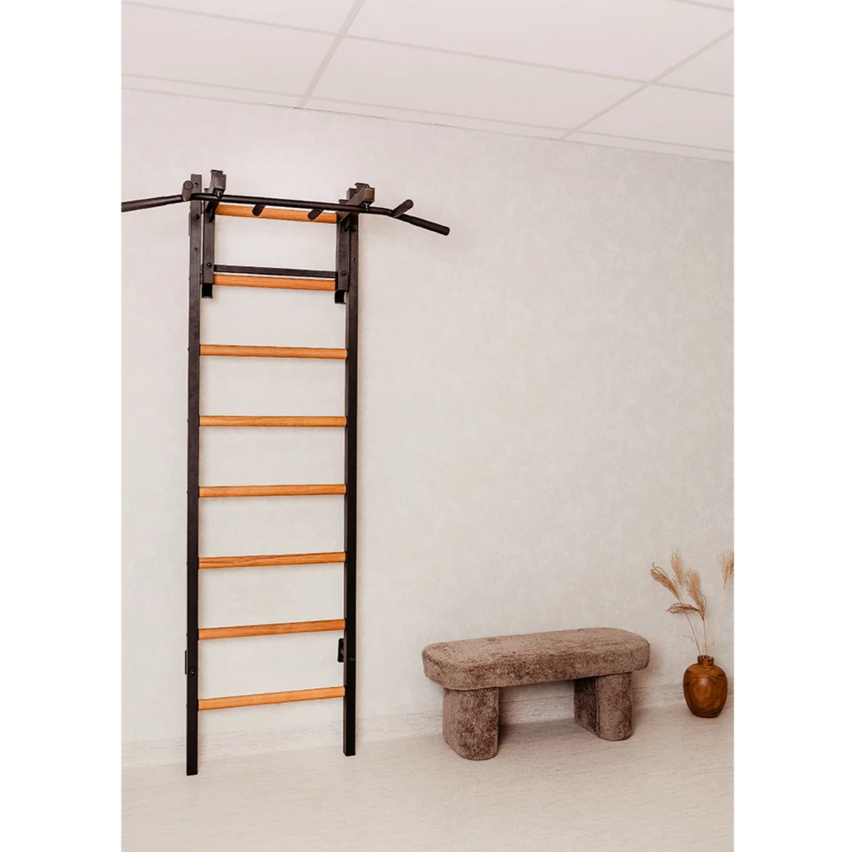 BenchK PB3 Steel Pull-Up Bar with barbell holder black version installed in a yoga studio.