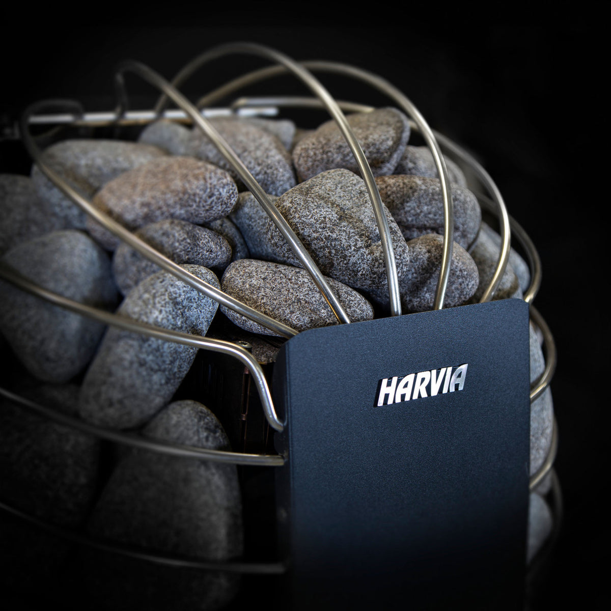 Close-up of the Harvia Spirit Electric Sauna Heater showcasing the gray sauna stones and Harvia branding.