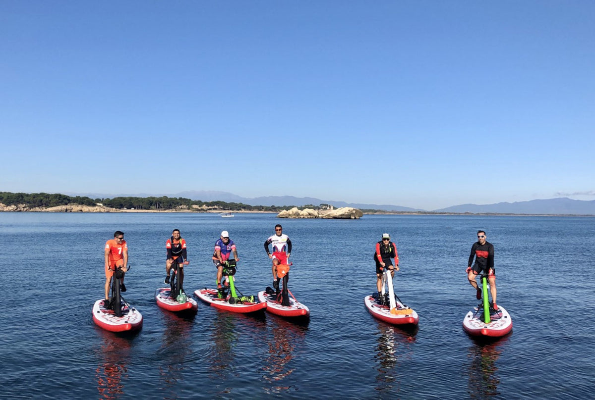 A group of people enjoying a day out on Red Shark Enjoy Bike Surfs with a clear blue sky in the backdrop.