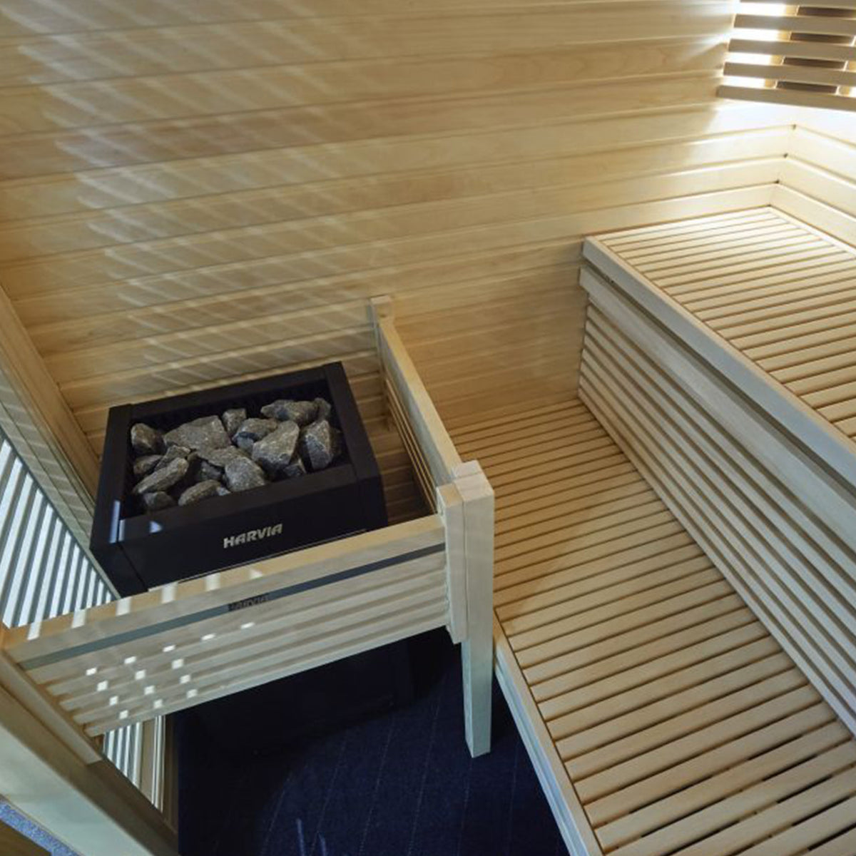 Harvia Virta Electric Sauna Heater with WiFi Remote Control Panel and 10.5 kW power installed in a modern sauna interior with wooden benches.