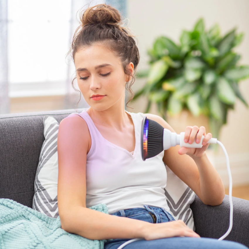 A woman using a Hooga Blue Light Therapy.