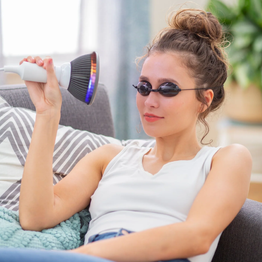 A woman using a Hooga Blue Light Therapy.