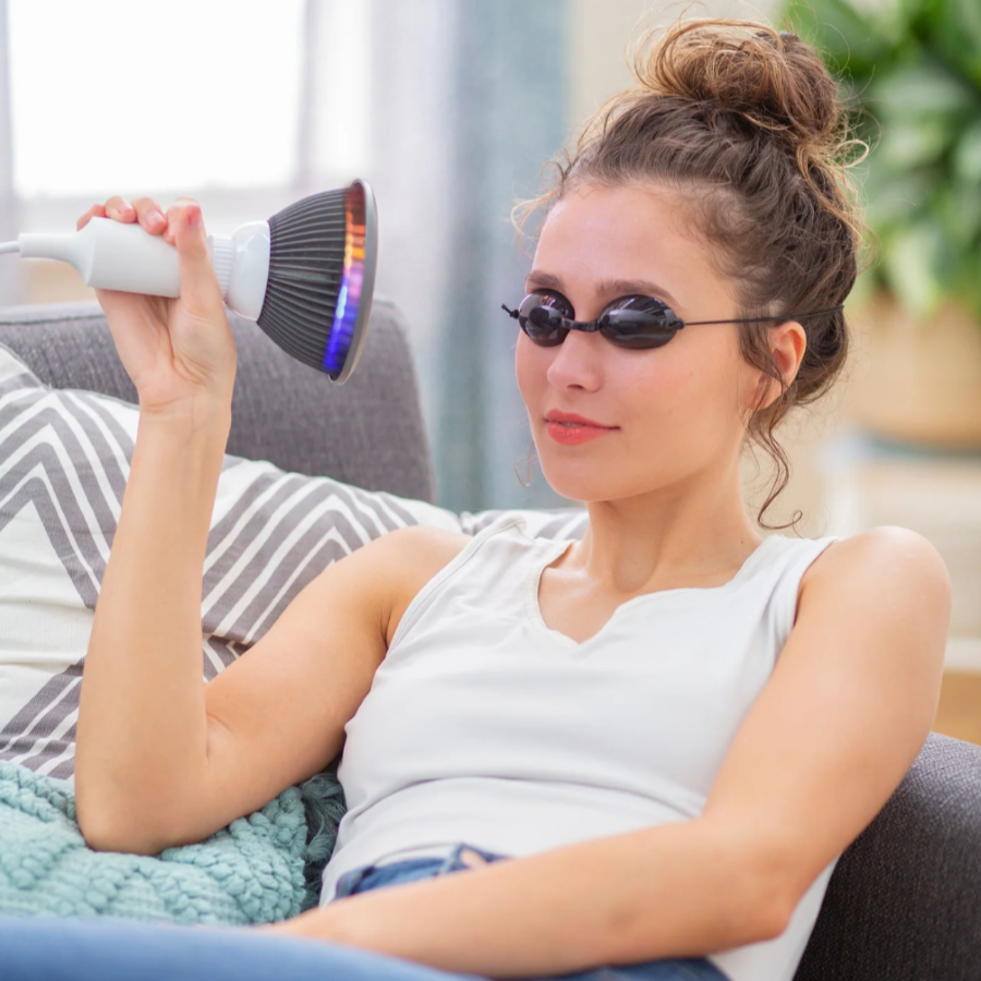 A woman using a Hooga Green LED Light Therapy.