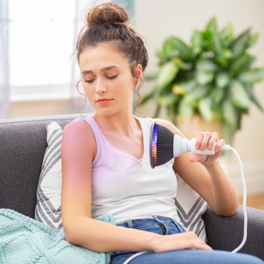 A woman using a Hooga Green LED Light Therapy.