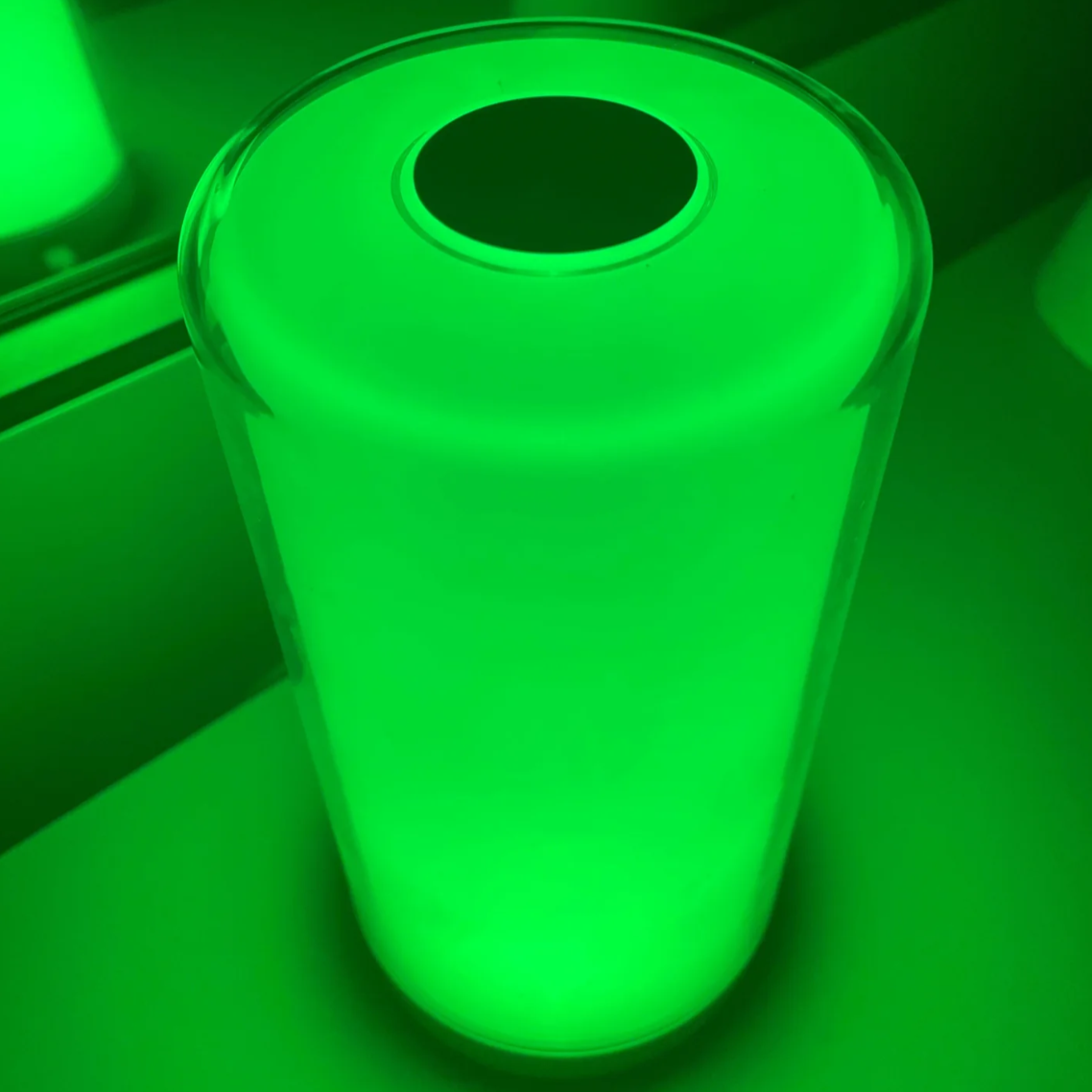 Hooga Green Light Therapy Migraine Relief Lamp being used in a dark room.