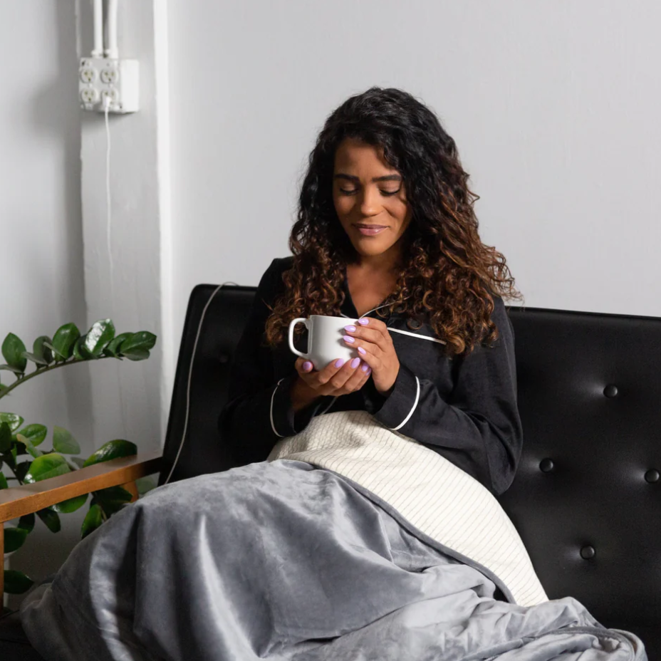 A woman using a Hooga Grounding Blanket.