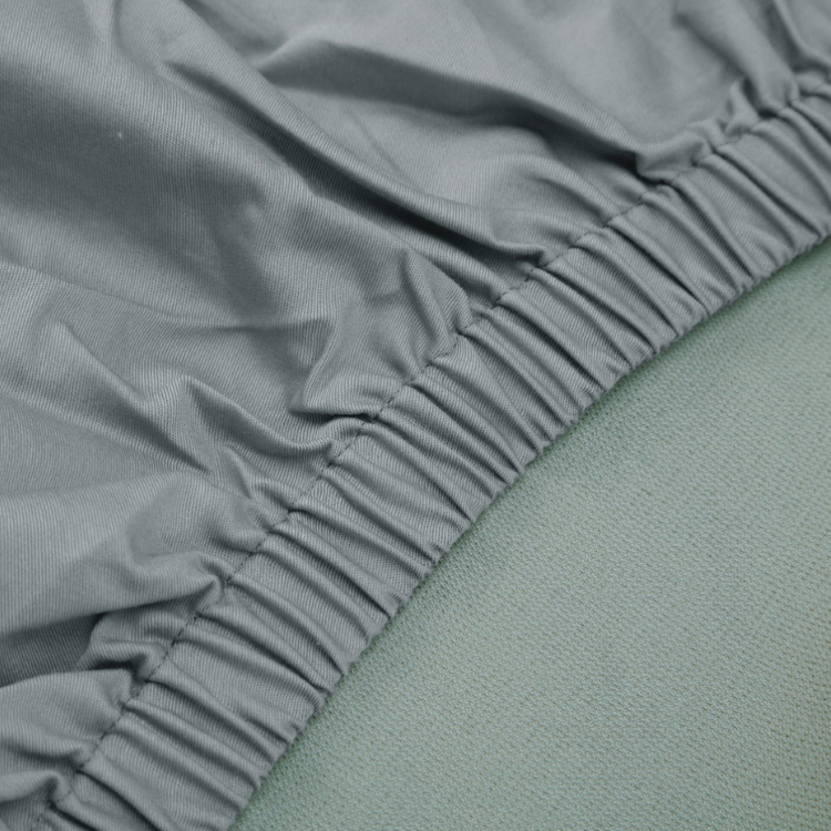 Close-up view of the elastic border of Hooga Grounding Crib Sheet.