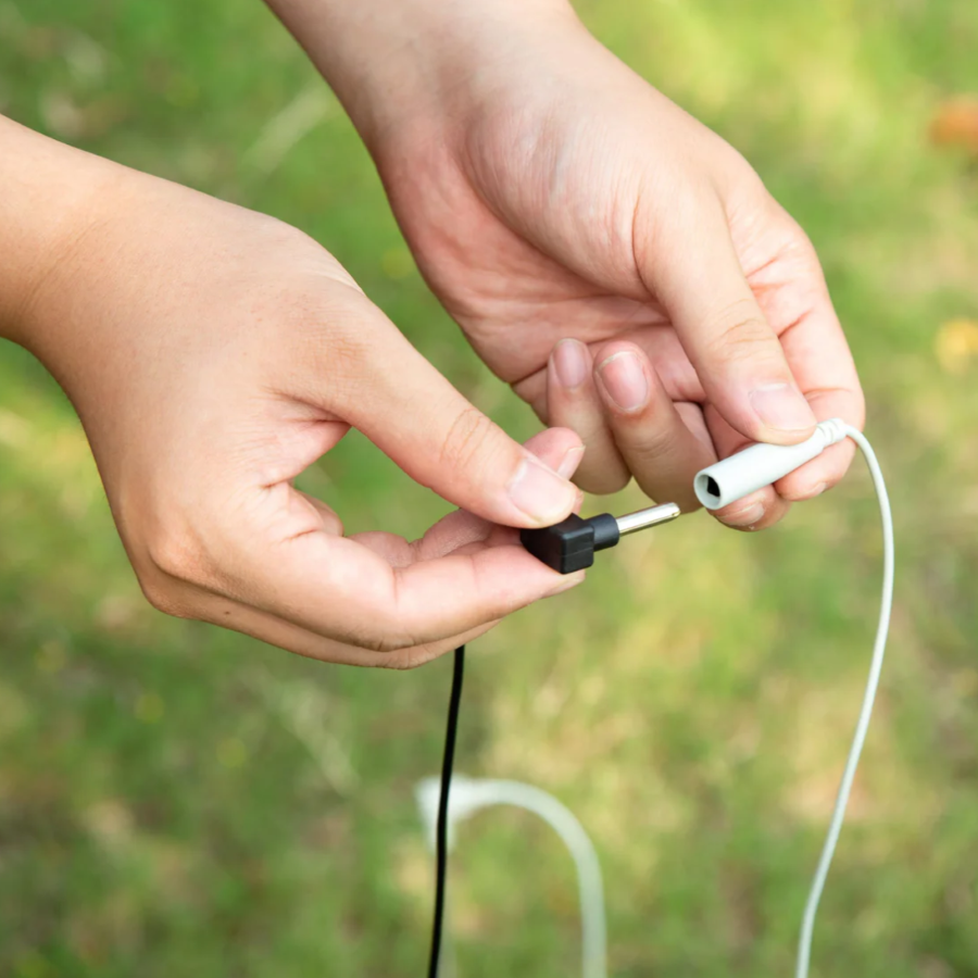 A person using a Hooga Grounding Rod.