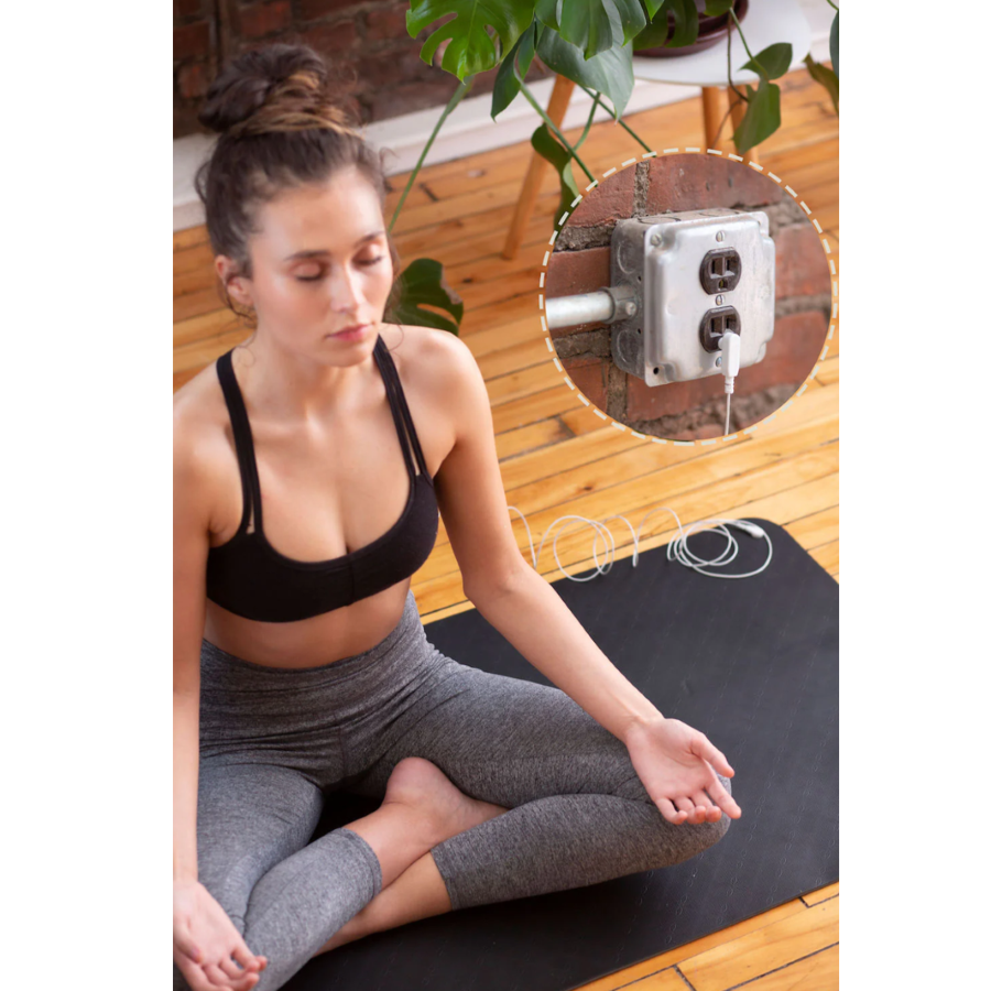 A woman using a Hooga Grounding Yoga Mat.