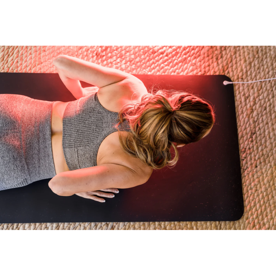 A woman using a Hooga Grounding Yoga Mat.