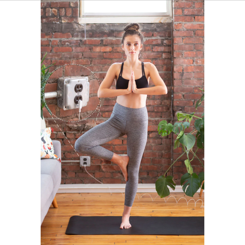 A woman using a Hooga Grounding Yoga Mat.