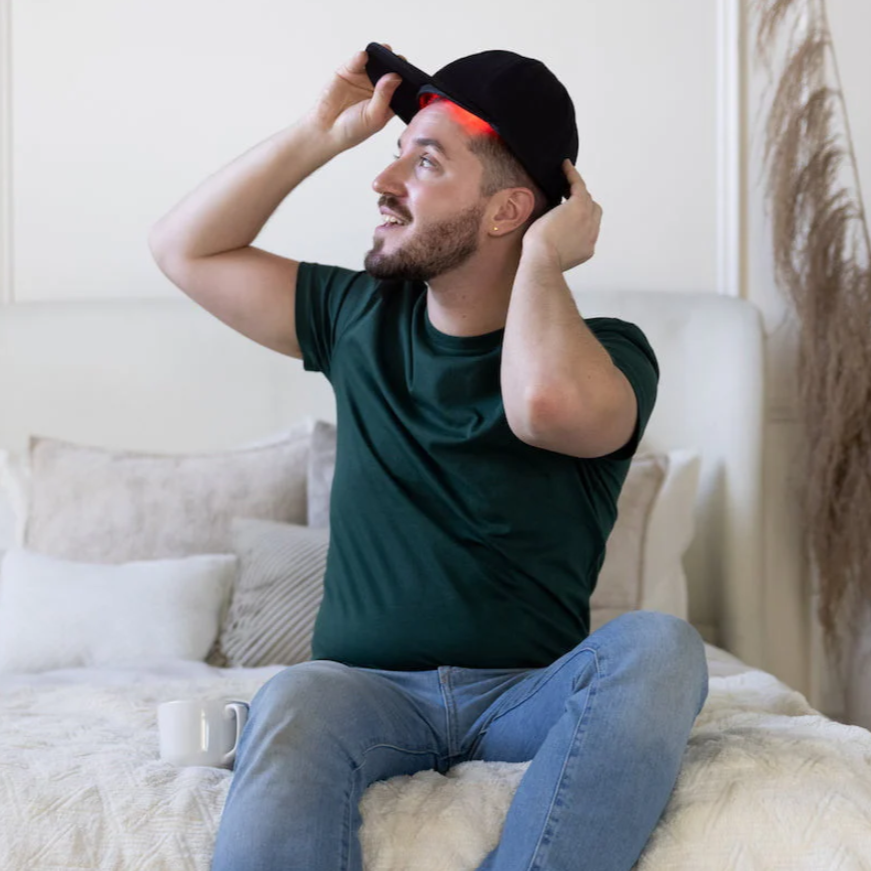 A man using a Hooga Red Light Therapy Hat.