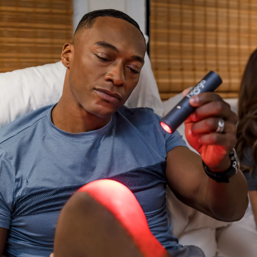 A man using a Hooga Red Light Therapy Torch.