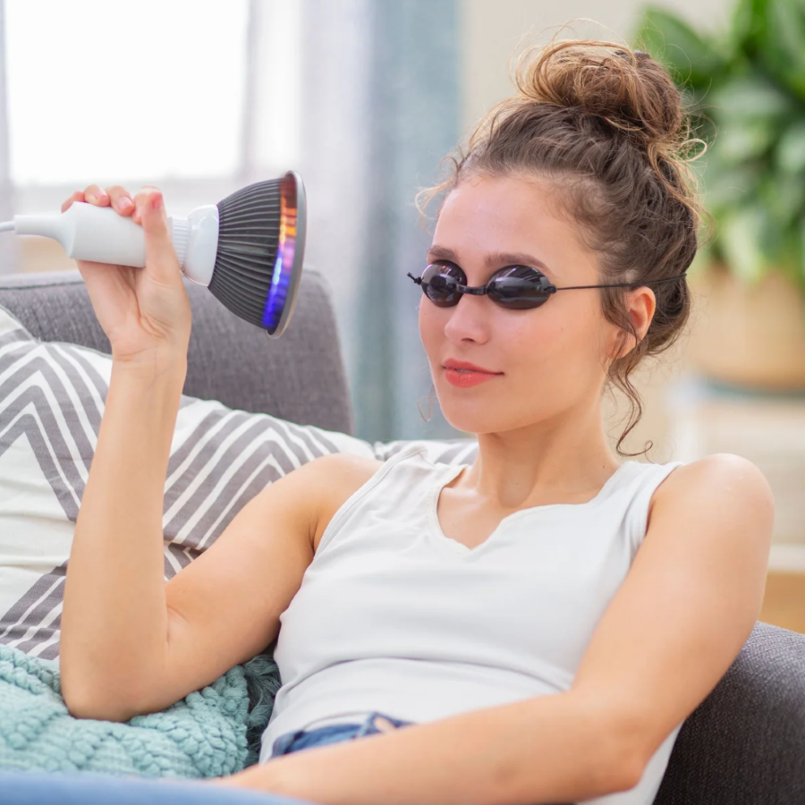 A woman using a Hooga Yellow LED Light Therapy.