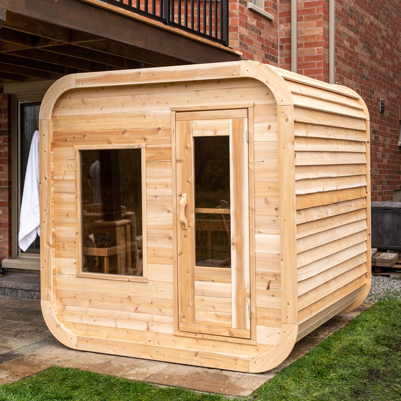 Diagonal view of Leisurecraft Canadian Timber Luna Outdoor Sauna in an outdoor setting.