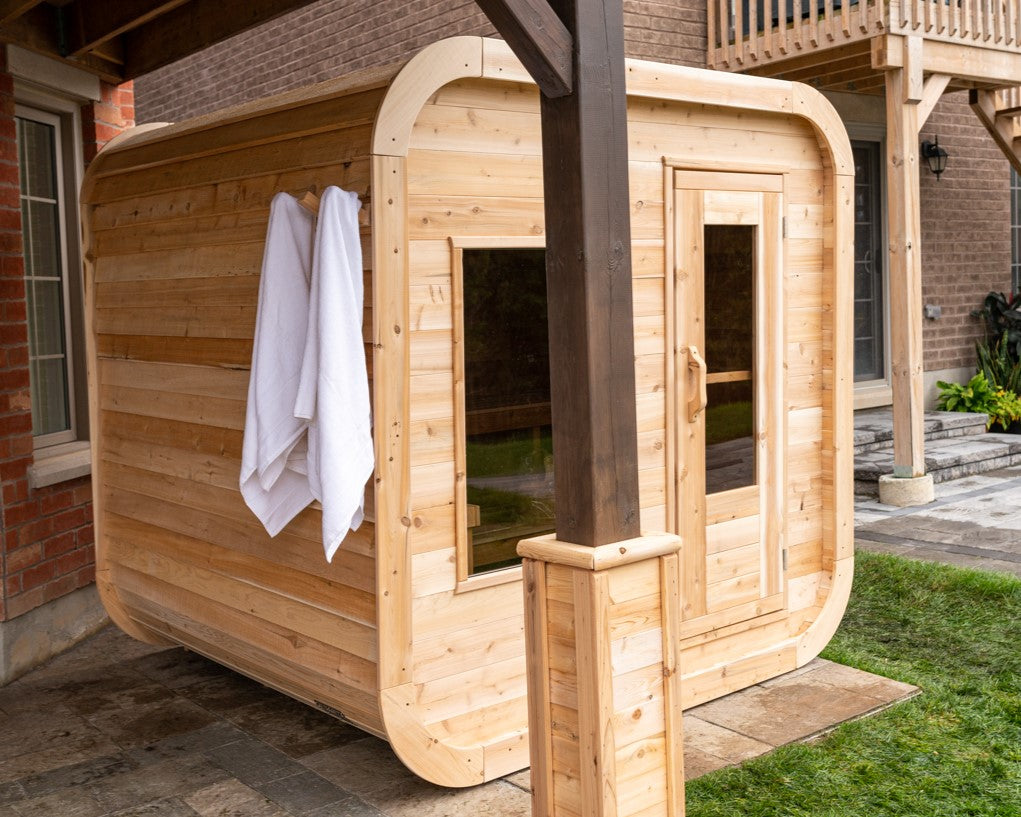 Diagonal view of Leisurecraft Canadian Timber Luna Outdoor Sauna in an outdoor setting.