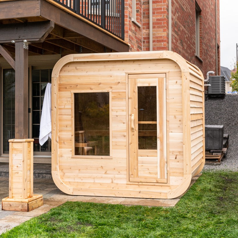 Diagonal view of Leisurecraft Canadian Timber Luna Outdoor Sauna in an outdoor setting.