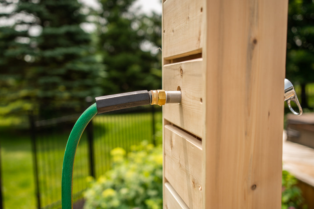 Close-up view of water supply connection of Leisurecraft Canadian Timber Sierra Outdoor Shower.