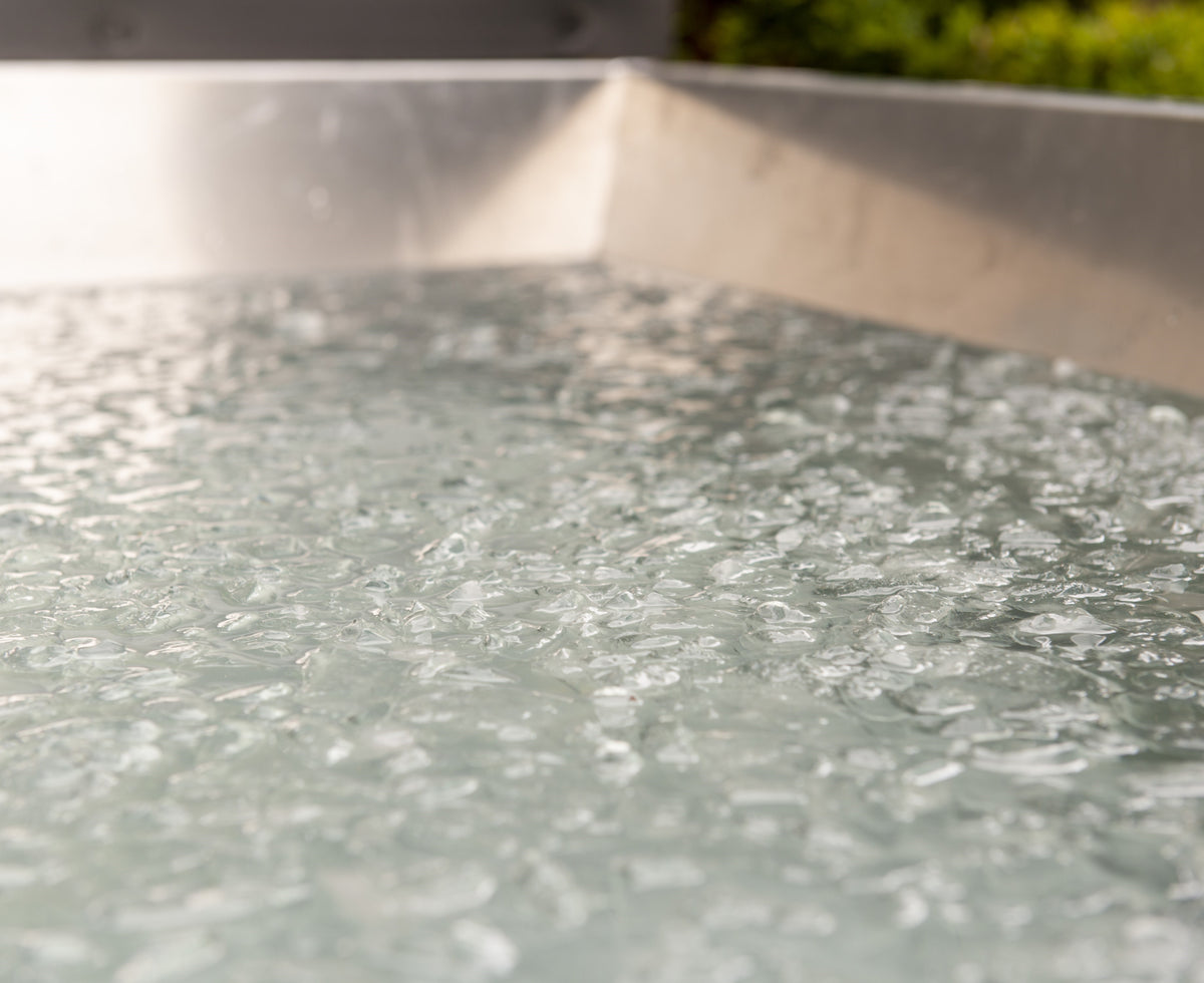 Close-up view of iced water inside a Leisurecraft Canadian Timber Polar Cold Plunge Tub, ready for a cold therapy session.