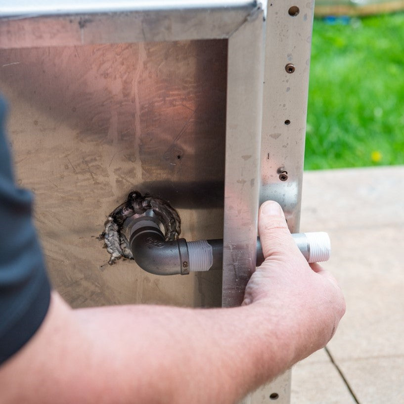 A man installing the Leisurecraft Canadian Timber Polar Cold Plunge Tub, showing how easily is done.